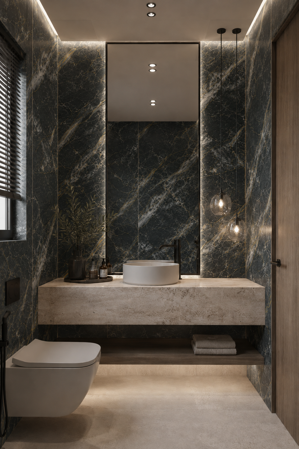 Baño con paredes de mármol negro veteado, lavabo sobre encimera clara e iluminación indirecta